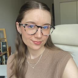 Chloe is a white female with brown hair, blue eyes, and glasses.