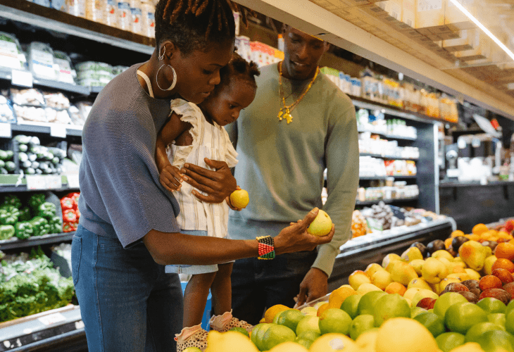 People Family in supermarket looking at fruit