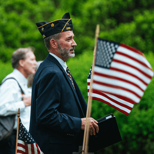 Veteran walking on the street with American Flag